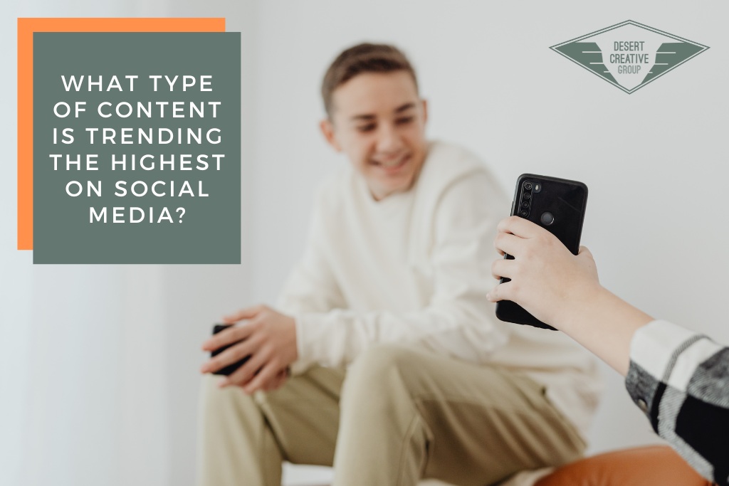 What Type of Content Is Trending the Highest on Social Media? Out of frame person shows young male a social media post on a mobile phone.